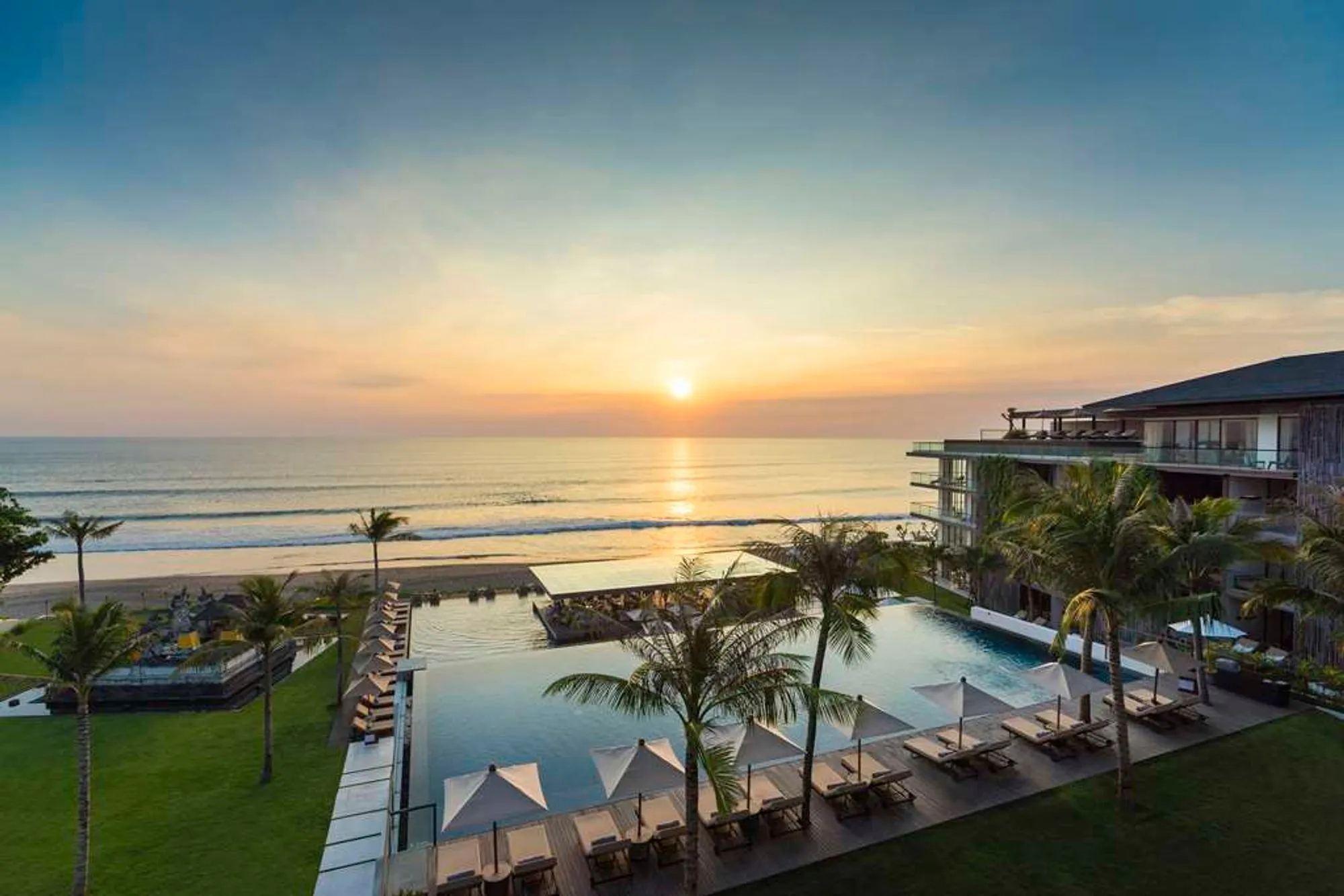 Alila Seminyak, Seminyak Bali - infinity pool and beachfront resort at sunset