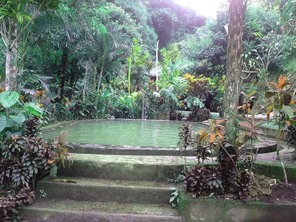Angseri Hot Spring mineral-green public pool with bathers, Tabanan Bali